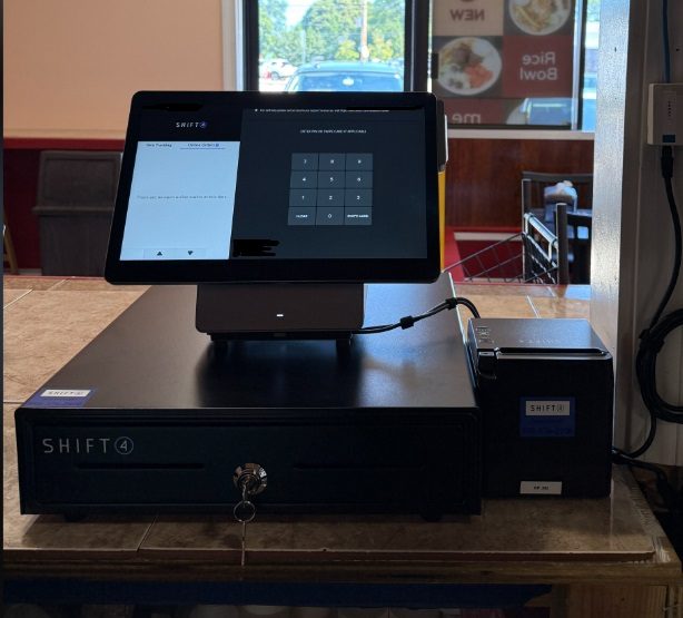A Shift4 point-of-sale terminal, cash drawer and receipt printer installed at a restaurant counter by Nelectron Solutions